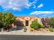 Charming single-story home featuring a tile roof, desert landscaping, and inviting front entrance at 12276 Caminita Pl, Las Vegas, NV 89138