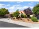 Inviting single-story home with desert landscaping, mature trees and a well-manicured lawn at 12276 Caminita Pl, Las Vegas, NV 89138