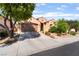 Charming single-story home showcasing desert landscaping, mature trees and a spacious three-car garage at 12276 Caminita Pl, Las Vegas, NV 89138