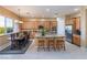 Bright kitchen with stainless steel appliances, island with bar seating, and ample cabinet space at 12276 Caminita Pl, Las Vegas, NV 89138