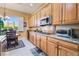 A well-equipped kitchen featuring ample wood cabinetry, granite countertops, and stainless steel appliances at 12276 Caminita Pl, Las Vegas, NV 89138