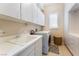 Well-organized laundry room with modern appliances, ample storage, and natural light, simplifying household chores at 12276 Caminita Pl, Las Vegas, NV 89138