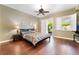 Comfortable main bedroom featuring hardwood floors, a ceiling fan, and access to the outdoors at 12276 Caminita Pl, Las Vegas, NV 89138