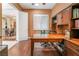 Another view of the office showcasing the hardwood floors, ample storage, and natural light at 12276 Caminita Pl, Las Vegas, NV 89138