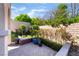 Secluded patio with mature landscaping, potted plants, and brick walls, offering a private outdoor retreat at 12276 Caminita Pl, Las Vegas, NV 89138