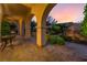 Covered patio with elegant arches, creating a serene outdoor space with landscaped planters and tranquil ambiance at 12276 Caminita Pl, Las Vegas, NV 89138