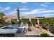 Well-maintained patio featuring outdoor dining area, lush greenery, and brick pavers at 12276 Caminita Pl, Las Vegas, NV 89138