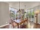 Bright dining room with large windows, hardwood flooring, and a spacious table at 1409 Chambolle Ct, Las Vegas, NV 89144