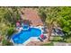 Aerial view of a private backyard oasis featuring a sparkling pool, spa, and lush landscaping at 1409 Chambolle Ct, Las Vegas, NV 89144