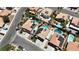 Overhead shot of closely situated homes with inviting pools, solar panels, and garden features at 1877 Glory Lily Ct, Las Vegas, NV 89123
