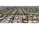 An aerial view showcases a community with well-maintained homes, pools, and mature landscaping in an urban setting at 1877 Glory Lily Ct, Las Vegas, NV 89123