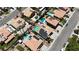 High angle view of a neighborhood showcasing houses with pools, lush greenery, and well-kept landscaping at 1877 Glory Lily Ct, Las Vegas, NV 89123