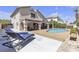 Relaxing backyard oasis featuring a covered patio, swimming pool, and lounge chairs at 1877 Glory Lily Ct, Las Vegas, NV 89123