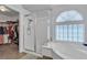 Elegant bathroom with a glass-enclosed shower and a separate soaking tub at 1877 Glory Lily Ct, Las Vegas, NV 89123