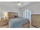 Well-lit bedroom featuring a queen bed and a large window with stylish shutters at 1877 Glory Lily Ct, Las Vegas, NV 89123