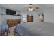 Bright bedroom with a TV, neutral colors, and a ceiling fan at 1877 Glory Lily Ct, Las Vegas, NV 89123
