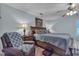 Bedroom with soft blue walls, a ceiling fan, and a comfortable armchair at 1877 Glory Lily Ct, Las Vegas, NV 89123