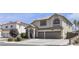 Classic two-story residence with a double garage, manicured shrubbery, and an attractive exterior color scheme at 1877 Glory Lily Ct, Las Vegas, NV 89123