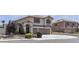 Inviting two-story home with a tile roof, arched entryway, and a spacious driveway, showcasing curb appeal at 1877 Glory Lily Ct, Las Vegas, NV 89123