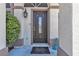 Elegant front door with decorative glass, flanked by manicured greenery and modern lighting fixtures at 1877 Glory Lily Ct, Las Vegas, NV 89123