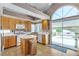 Bright kitchen with ample cabinets, white appliances, and sliding door to outdoor pool area at 1877 Glory Lily Ct, Las Vegas, NV 89123