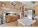 Kitchen with stainless fridge, tile floors, and unique wooden cabinet/storage unit at 1877 Glory Lily Ct, Las Vegas, NV 89123