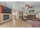 Cozy living room with fireplace, media center, and view of a windowed room at 1877 Glory Lily Ct, Las Vegas, NV 89123