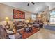 Cozy living room showcasing plush seating, a decorative rug, and natural light filtering through the windows at 1877 Glory Lily Ct, Las Vegas, NV 89123
