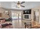 Comfortable living room with fireplace, workout equipment, and a view of the backyard pool at 1877 Glory Lily Ct, Las Vegas, NV 89123