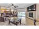Bright living room with tile flooring, exercise equipment, fireplace, and a view of the backyard pool at 1877 Glory Lily Ct, Las Vegas, NV 89123