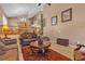 Comfortable living space featuring tiled floors, ample seating, and a view of the staircase and dining area at 1877 Glory Lily Ct, Las Vegas, NV 89123