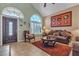 Inviting living room with a high ceiling, neutral color scheme, and comfortable seating arrangements by the front door at 1877 Glory Lily Ct, Las Vegas, NV 89123