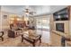 Inviting living room with fireplace, view of backyard pool, and casual seating area at 1877 Glory Lily Ct, Las Vegas, NV 89123