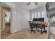 Home office features natural light, a desk and chair and a wardrobe at 1877 Glory Lily Ct, Las Vegas, NV 89123