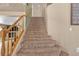 Carpeted staircase with wood railing leads to the upper level of the home at 1877 Glory Lily Ct, Las Vegas, NV 89123