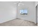 Bright bedroom featuring plush carpet, a ceiling fan, and a large window offering scenic neighborhood views at 1881 W Alexander Rd # 2093, North Las Vegas, NV 89032
