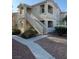 Multi-story building showcasing architectural details and well-maintained landscaping at 1881 W Alexander Rd # 2093, North Las Vegas, NV 89032