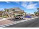 Exterior view of condo building with covered parking and tidy landscaping at 1881 W Alexander Rd # 2093, North Las Vegas, NV 89032