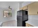 Well-lit kitchen offers ample cabinet space and includes stainless steel appliances, complemented by neutral tile flooring at 1881 W Alexander Rd # 2093, North Las Vegas, NV 89032