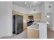 Well-equipped kitchen with stainless steel appliances, light wood cabinetry, and a breakfast bar for casual dining at 1881 W Alexander Rd # 2093, North Las Vegas, NV 89032