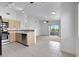 Bright kitchen features stainless steel appliances and flows into a carpeted living area with balcony access at 1881 W Alexander Rd # 2093, North Las Vegas, NV 89032