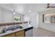 Bright kitchen with tile floors featuring a breakfast bar that opens up to a dining area and the entry door at 1881 W Alexander Rd # 2093, North Las Vegas, NV 89032