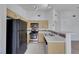 This open kitchen design features stainless steel appliances, light wood cabinets, and plenty of natural light at 1881 W Alexander Rd # 2093, North Las Vegas, NV 89032