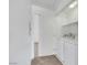 A functional laundry area includes a full-size washer and dryer, plus upper shelving for storage and organization at 1881 W Alexander Rd # 2093, North Las Vegas, NV 89032