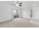 Open living room featuring vaulted ceiling, carpeting, and sliding glass door to balcony at 1881 W Alexander Rd # 2093, North Las Vegas, NV 89032