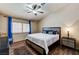 Bedroom featuring wood floors, large window, ceiling fan and modern furniture at 2035 E Warm Springs Rd # 1019, Las Vegas, NV 89119