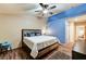 This bedroom offers a walk through layout, a painted accent wall, and wood-look flooring at 2035 E Warm Springs Rd # 1019, Las Vegas, NV 89119