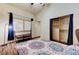 Bedroom featuring wood-look floors, a closet with organizers, and a window with shutters at 2035 E Warm Springs Rd # 1019, Las Vegas, NV 89119