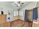 Cozy bedroom featuring wood floors, an open closet, and a window with plantation shutters at 2035 E Warm Springs Rd # 1019, Las Vegas, NV 89119