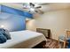 Comfortable bedroom showcasing a painted accent wall, ceiling fan, and wood-look flooring at 2035 E Warm Springs Rd # 1019, Las Vegas, NV 89119
